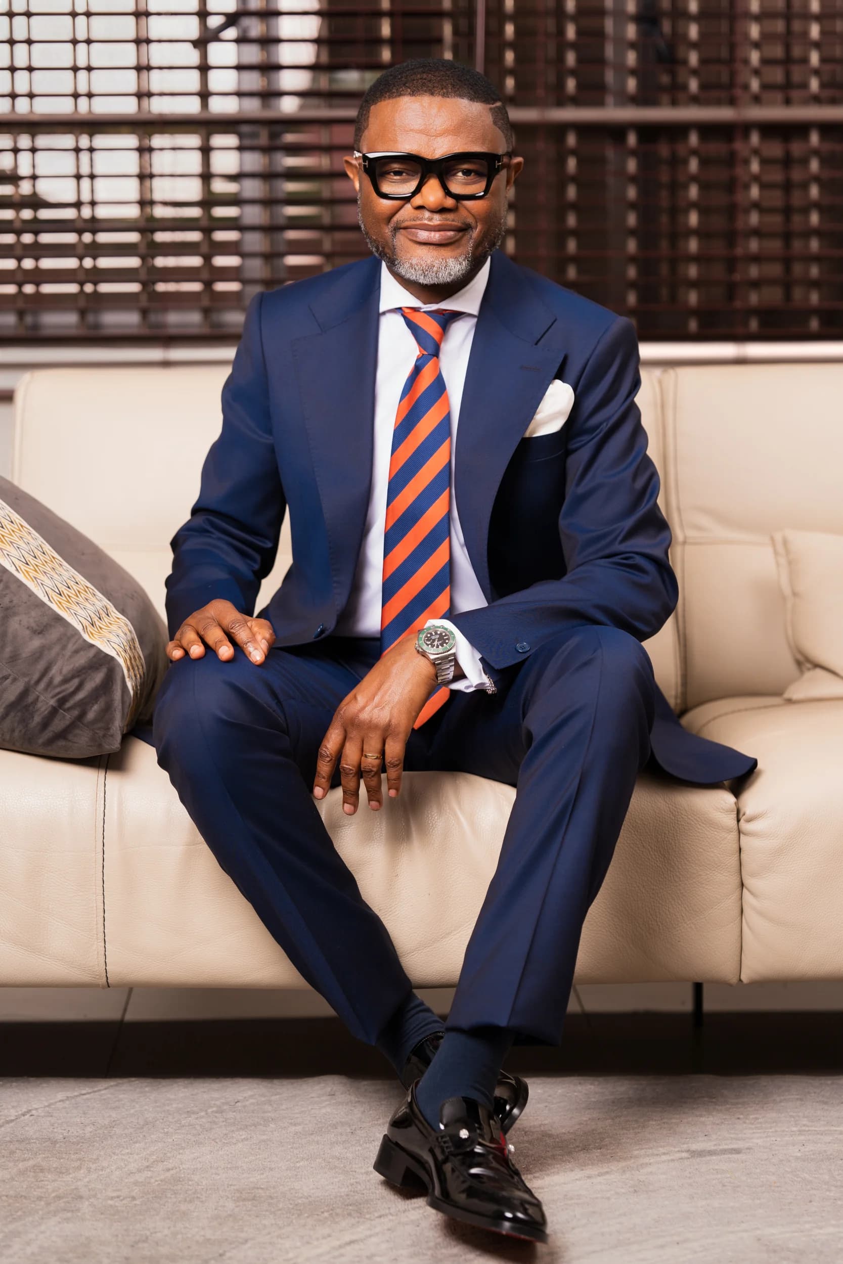Benedicto Bena Nkhoma seated in a navy suit and striped tie
