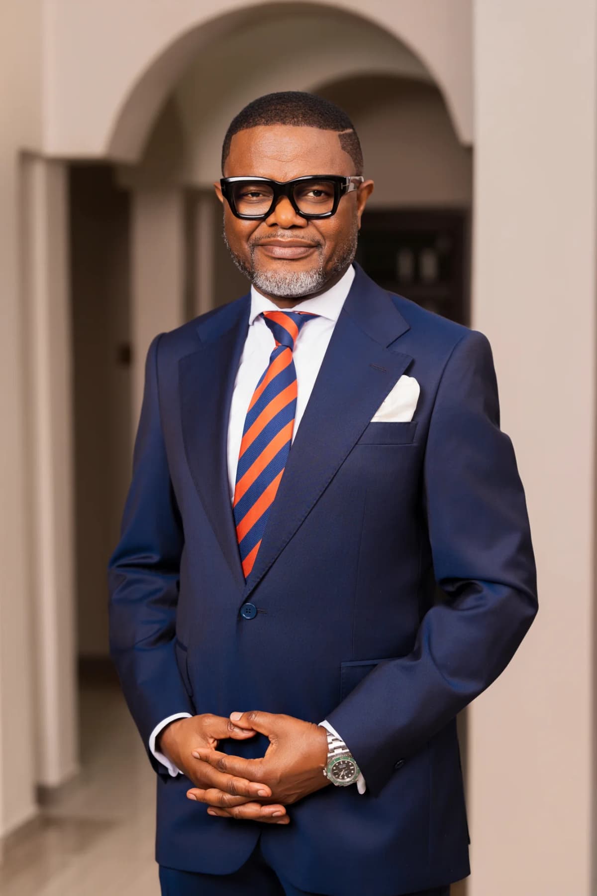 Bena Nkhoma standing in a navy suit and striped tie