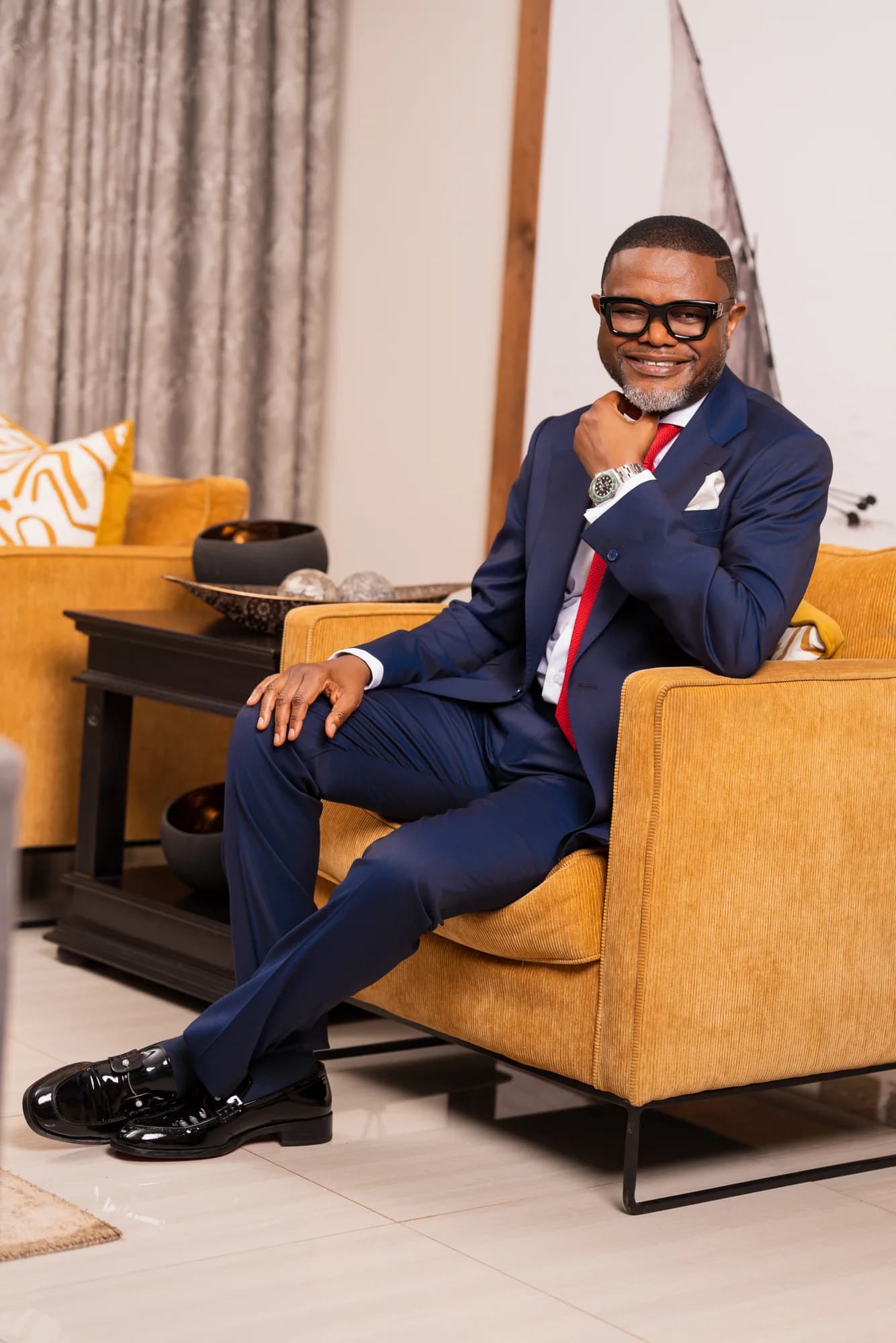Bena Nkhoma seated with a red tie